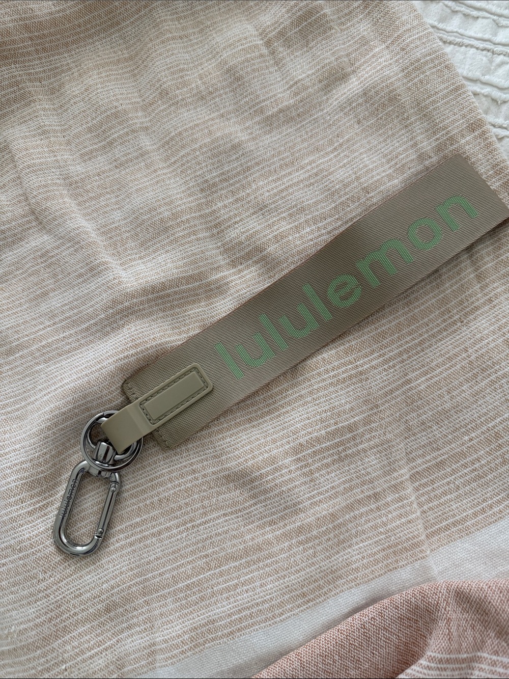 lululemon athletica beige key/card holder strap with green logo